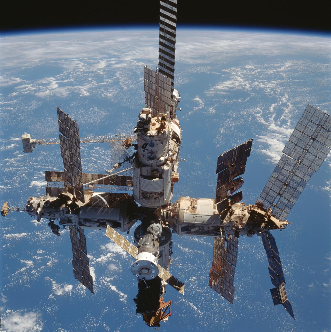 STS091-727-051 (2-12 June 1998) --- Russia's Mir space station is backdropped over the blue and white planet Earth in this medium range photograph recorded during the final fly-around of the members of the fleet of NASA's shuttles.  Seven crew members, including Andrew S.W. Thomas, were aboard the Discovery when the photo was taken; and two of his former cosmonaut crewmates remained aboard Mir.  Thomas ended up spending 141 days in space on this journey, including time aboard the Space Shuttles Endeavour and Discovery, which delivered and retrieved him to and from the Mir.
