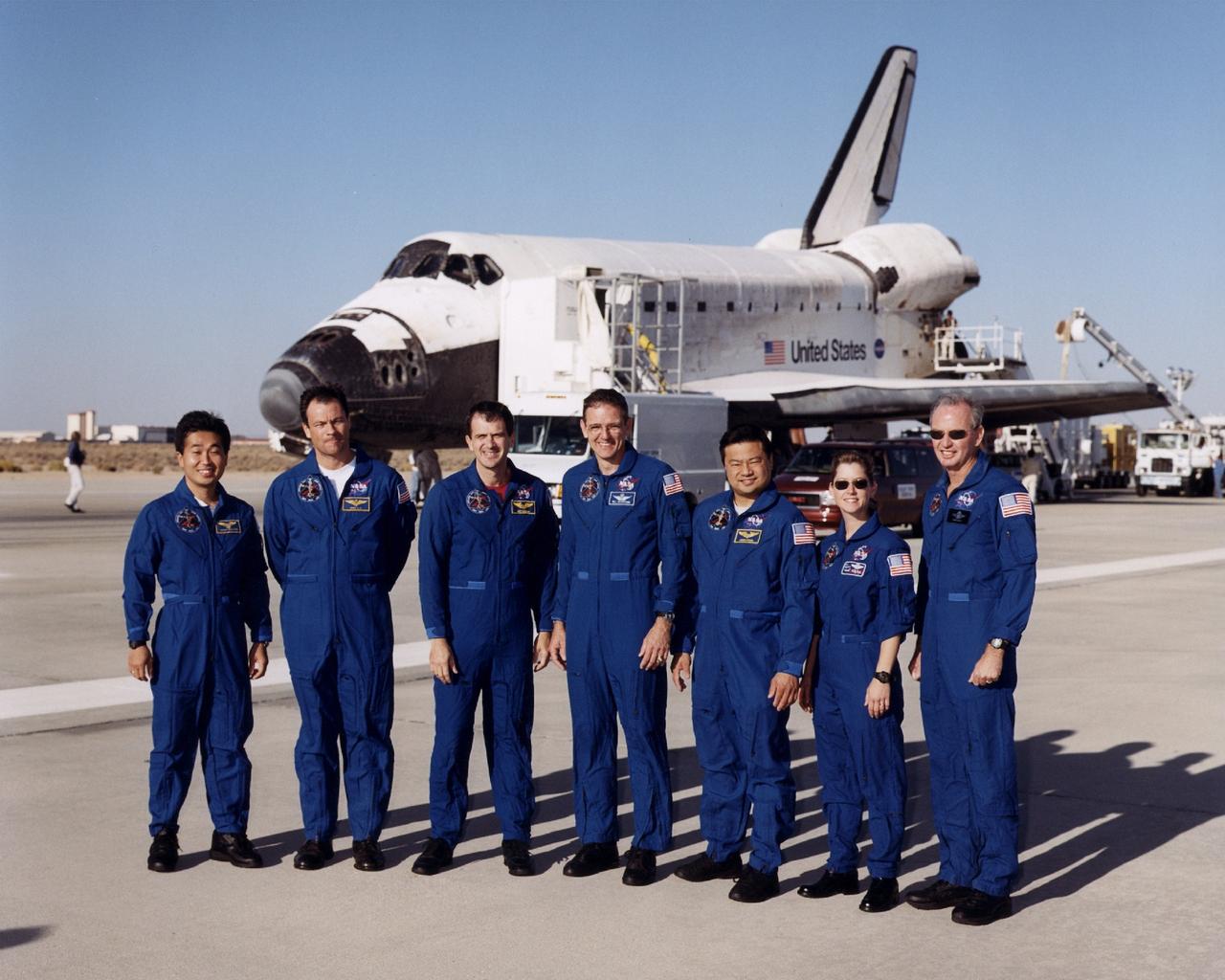 STS092-S-023 [EC00-0311-4] (24 October 2000)--- The seven astronauts for the STS-92 flight, having just returned from a mission in Earth orbit aboard the Space Shuttle Discovery, pose near that  vehicle at Edwards Air Force Base in the Mojave Desert of California.  From the left are astronauts Koichi Wakata of Japan's National Space Development Agency (NASDA), Michael E. Lopez-Alegria, Peter J.K. (Jeff) Wisoff, William S. McArthur, Jr., Leroy Chiao, Pamela A. Melroy and Brian Duffy.  Discovery touched down at 2 p.m. (PDT), October 24, and rolled to a stop on Edward's concrete runway at 2:0l, for a mission elapsed time of 12 days, 21 hours and 43 minutes.