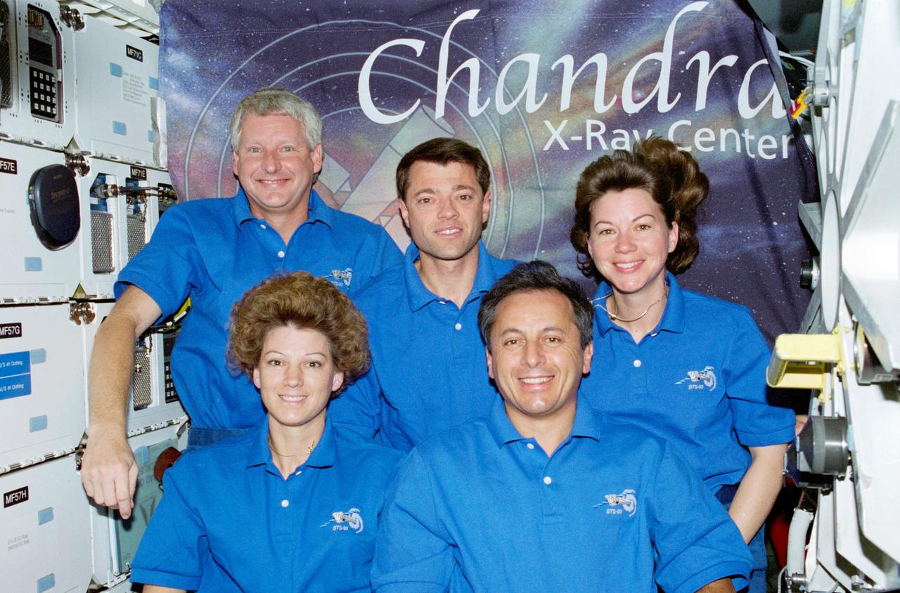 STS093-322-017 (23-27 July 1999) ---  The five STS-93 astronauts pose for the traditional inflight crew portrait on  Columbia's middeck.  In front are astronauts Eileen M. Collins, mission commander, and Michel Tognini, mission specialist, representing France's  Centre National d'Etudes Spatiales (CNES).  Behind them are (from the left)  astronauts Steven A. Hawley, mission specialist; Jeffrey S. Ashby, pilot; and Catherine G. (Cady) Coleman, mission specialist.