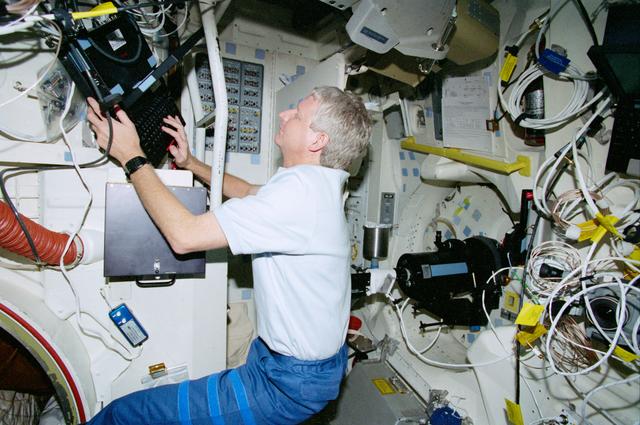 NASA image: STS-93 MS Hawley works with data associated with the OCA on the middeck