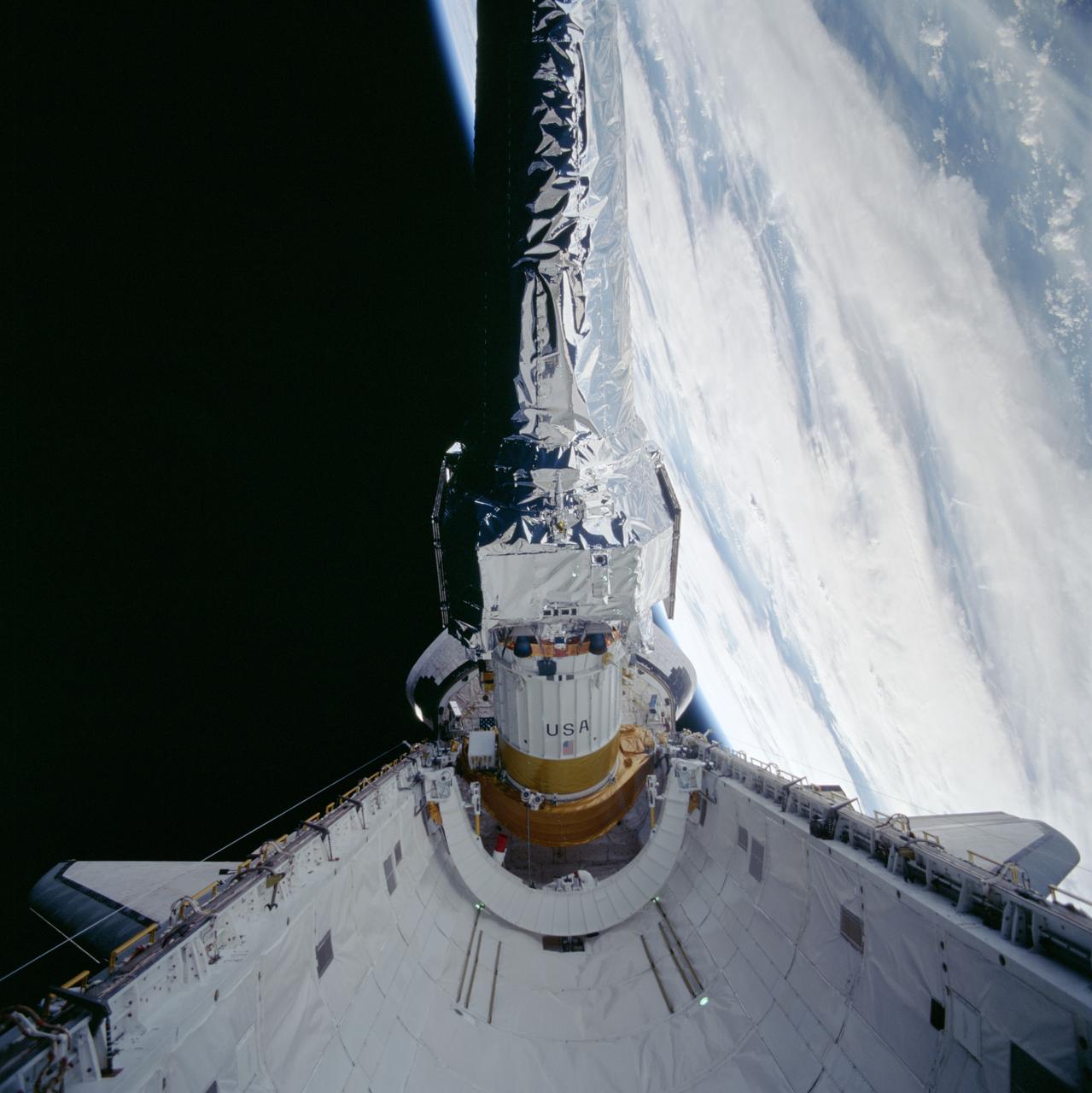 STS093-703-011 (22-27 July 1999) --- This 70mm frame shows the Chandra X-Ray observatory during its deployment from the Space Shuttle Columbia&#0146;s payload bay. The primary duty of the STS-93 crew was to deploy the world&#0146;s most powerful X-Ray telescope. It was also one of the first actions of the astronauts, occurring just a few hours following the shuttle&#0146;s arrival in Earth orbit. This scene is one of a series of still photos recorded by the crew before and during the deployment of the 50,162-pound observatory.