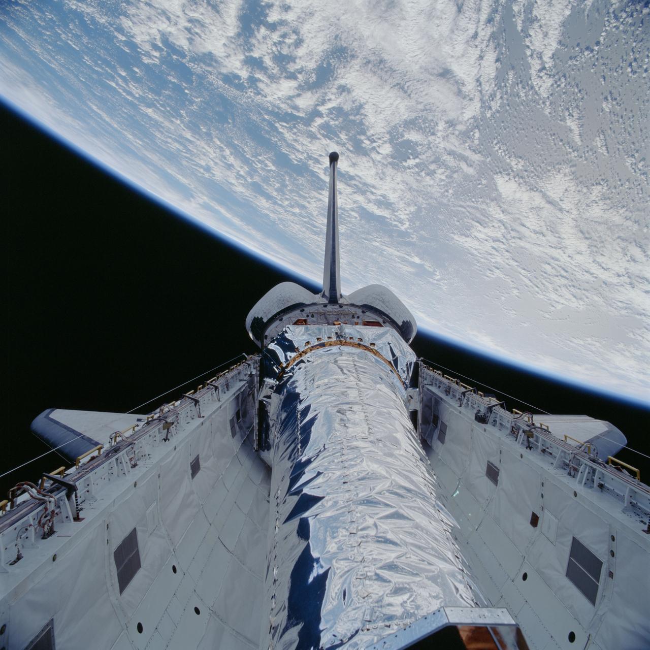 STS093-705-020 (23 July 1999)--- This 70mm frame shows the Chandra X-Ray observatory just before it was tilted upward for its release from Columbia's payload bay. The primary duty of the STS-93 crew was to deploy the world's most powerful X-Ray telescope. It was also one of the first actions of the astronauts, occurring just a few hours following the shuttle's arrival in Earth orbit. This scene is one of a series of still photos recorded by the crew before and during the deployment of the 50,162 pound observatory.