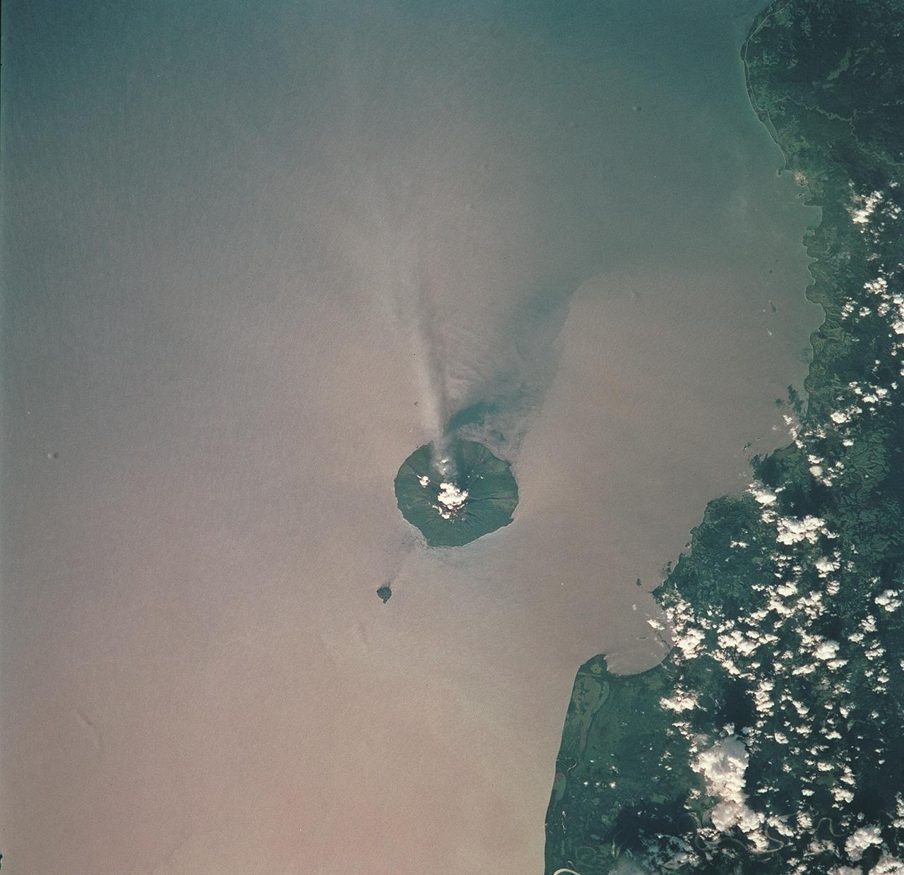 STS093-709-051 (23-27 July 1999) --- The STS-93 astronauts aboard the Space Shuttle Columbia took this picture of the volcanic island of Manam, along the northeast coast of Papua New Guinea. Manam is one in a string of currently active volcanoes called the Bismarck Arc. It is the most active of the group, having begun its present activity in 1994. The plume of steam and ash streaming from its crater extends more than 20 miles into the atmosphere. When the photo was taken, the shuttle was flying over a point located at 12.2 degrees south latitude and 132.0 degrees east longitude. Data back information on the 70mm film lists time and date of the photo as 05:42:31 GMT, July 25, 1999 (orbit 33).