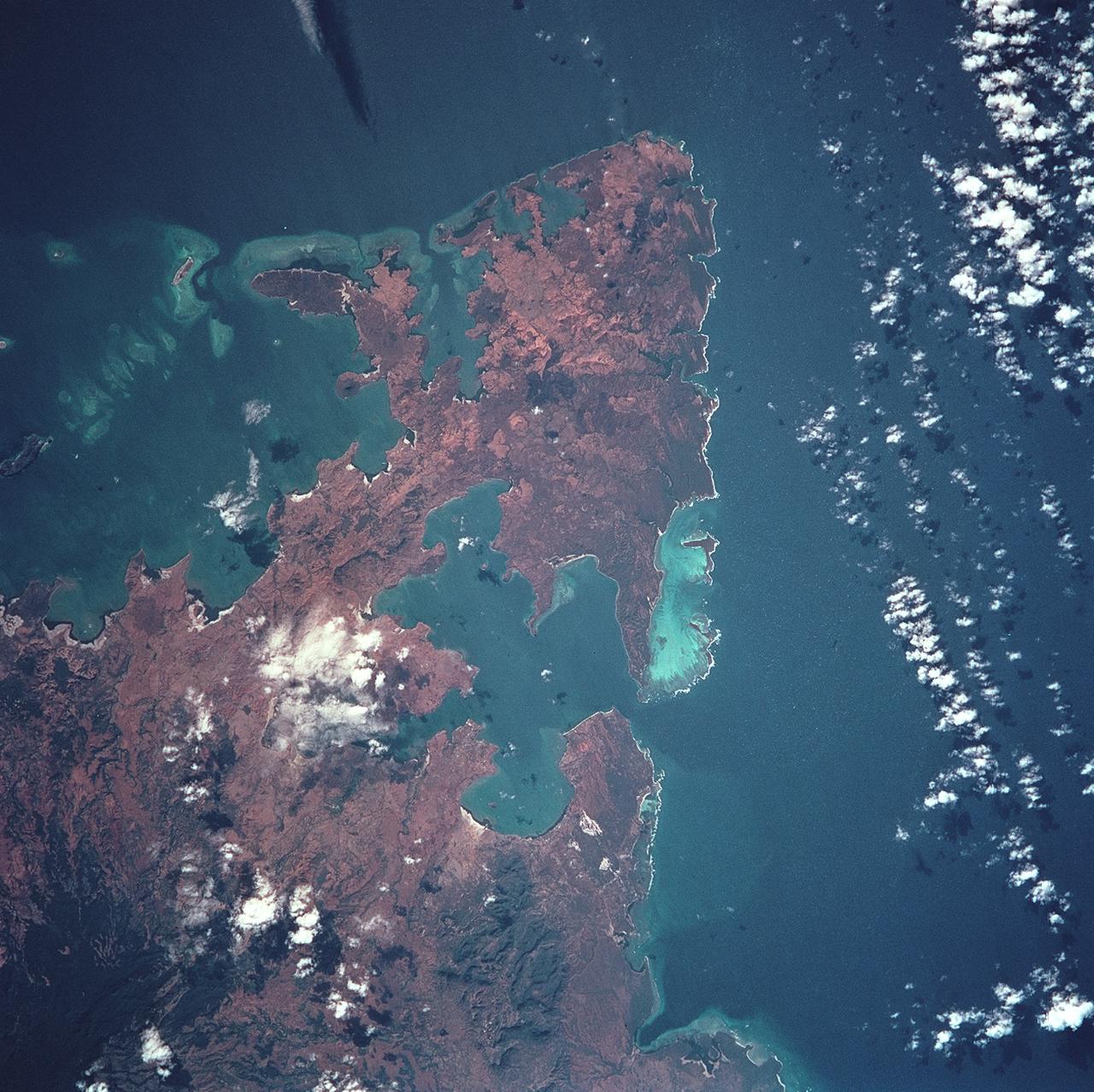 STS093-722-051 (23-27 July 1999) --- The STS-93 astronauts aboard the Space Shuttle Columbia took this picture over the Indian Ocean. The distinctive arrowhead shape of the northern tip of the island of Madagascar is easily recognizable. The land appears red with patches of dark green on the upper slopes. According to NASA scientists studying the STS-93 photo collection, the dark areas are the remnants of forests and the red areas are cleared land. When the photo was taken, the shuttle was flying over a point located at 14.7 degrees south latitude and 44.0 degrees east longitude. Data back information on the 70mm film listed the date and time of the photo as 11:38:20 GMT, July 24, 1999 (Orbit 21).