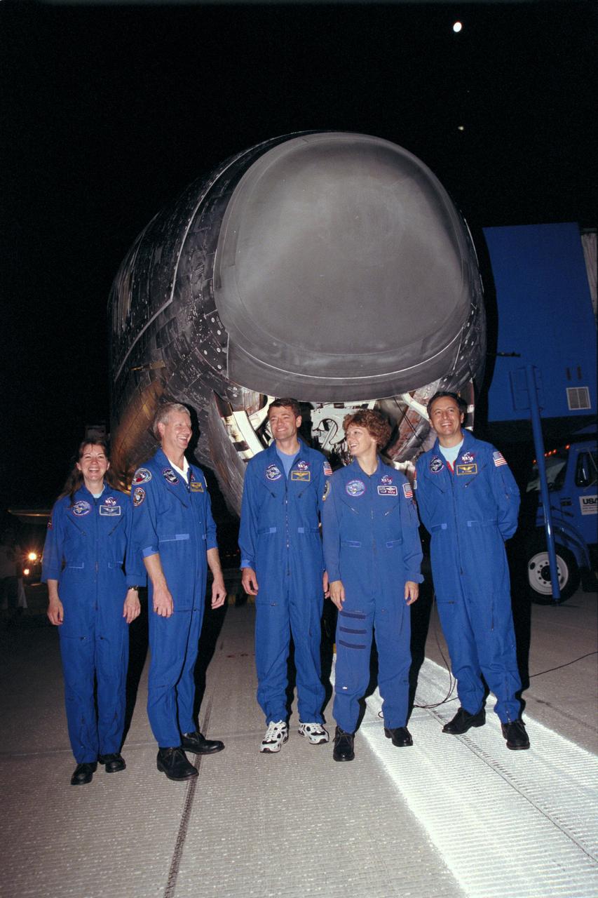 STS093-(S)-016 (27 July 1999) --- Members of the STS-93 crew pose in front of the Space Shuttle Columbia following the night landing on runway 33 at Kennedy Space Center's Shuttle Landing Facility. From the left are astronauts Catherine G. (Cady) Coleman and Steven A. Hawley, both mission specialists; Jeffrey S. Ashby, pilot; Eileen M. Collins, mission commander; and Michel Tognini, mission specialist representing France's Centre National d'Etudes Spatiales (CNES). Main gear touchdown occurred at 11:20:35 p.m.(EDT), July 27, 1999.