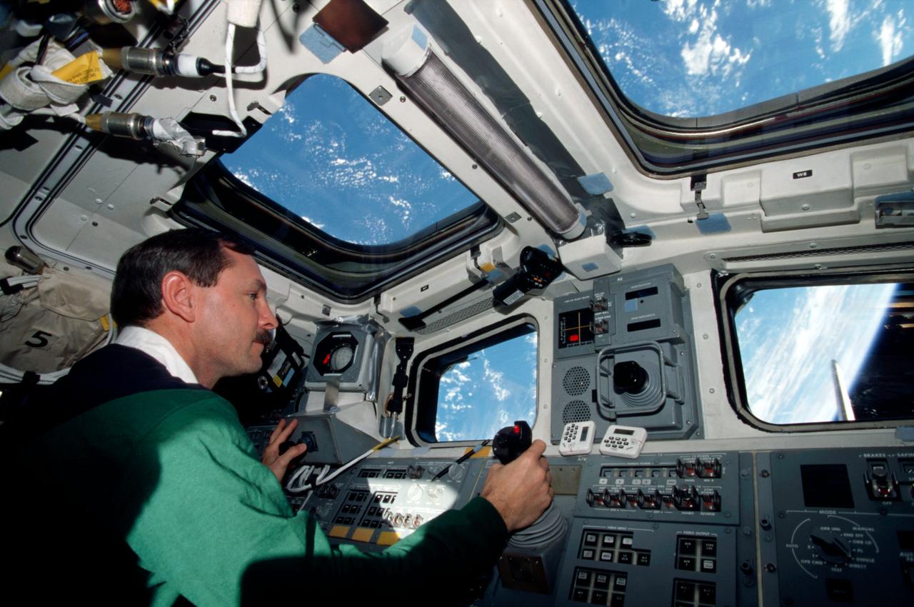 STS095-366-031 (29 Oct-7 Nov 1998) --- Astronaut Curtis L. Brown, Jr., mission commander, operates controls on the aft flight deck of the Space Shuttle Discovery. Brown was joined by four other NASA astronauts and two payload specialists for the nine-day mission.