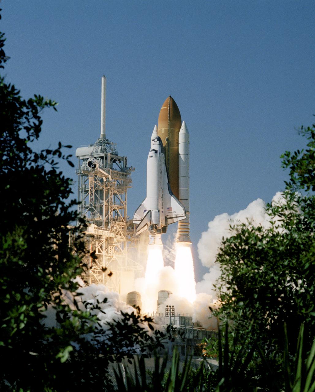 STS095-S-005 (29 Oct. 1998) --- Partially framed by Florida foliage, the space shuttle Discovery lifts off Launch Pad 39B to begin a nine-day mission in Earth orbit. Launch was at 2:19 p.m. (EST), Oct. 29, 1998. Onboard were Curtis L. Brown Jr., Steven W. Lindsey, Scott E. Parazynski, Steven K. Robinson, Pedro Duque, United States Senator John H. Glenn Jr. and Chiaki Naito-Mukai. Duque is a mission specialist representing the European Space Agency (ESA) and Mukai is a payload specialist representing Japan's National Space Development Agency (NASDA). Glenn, making his second spaceflight but his first in 36 years, joins Mukai as a payload specialist on the mission. Photo credit: NASA