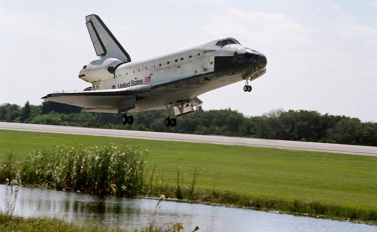 STS095-S-010 (7 Nov. 1998) --- The space shuttle Discovery's main landing gear is just about to touch down on Runway 33 at the Shuttle Landing Facility at the Kennedy Space Center (KSC). Main gear touchdown was at 12:04 p.m. (EST), landing on orbit 135. Discovery returned to Earth with its crew of five astronauts and two payload specialists to successfully complete the nine-day mission. Onboard were astronauts Curtis L. Brown Jr., Steven W. Lindsey, Scott F. Parazynski, Stephen K. Robinson, Pedro Duque and payload specialists Chiaki Naito-Mukai and United States Senator John H. Glenn Jr.  Duque represents the European Space Agency (ESA) and Mukai is with Japan's National Space Development Agency (NASDA). Photo credit: NASA