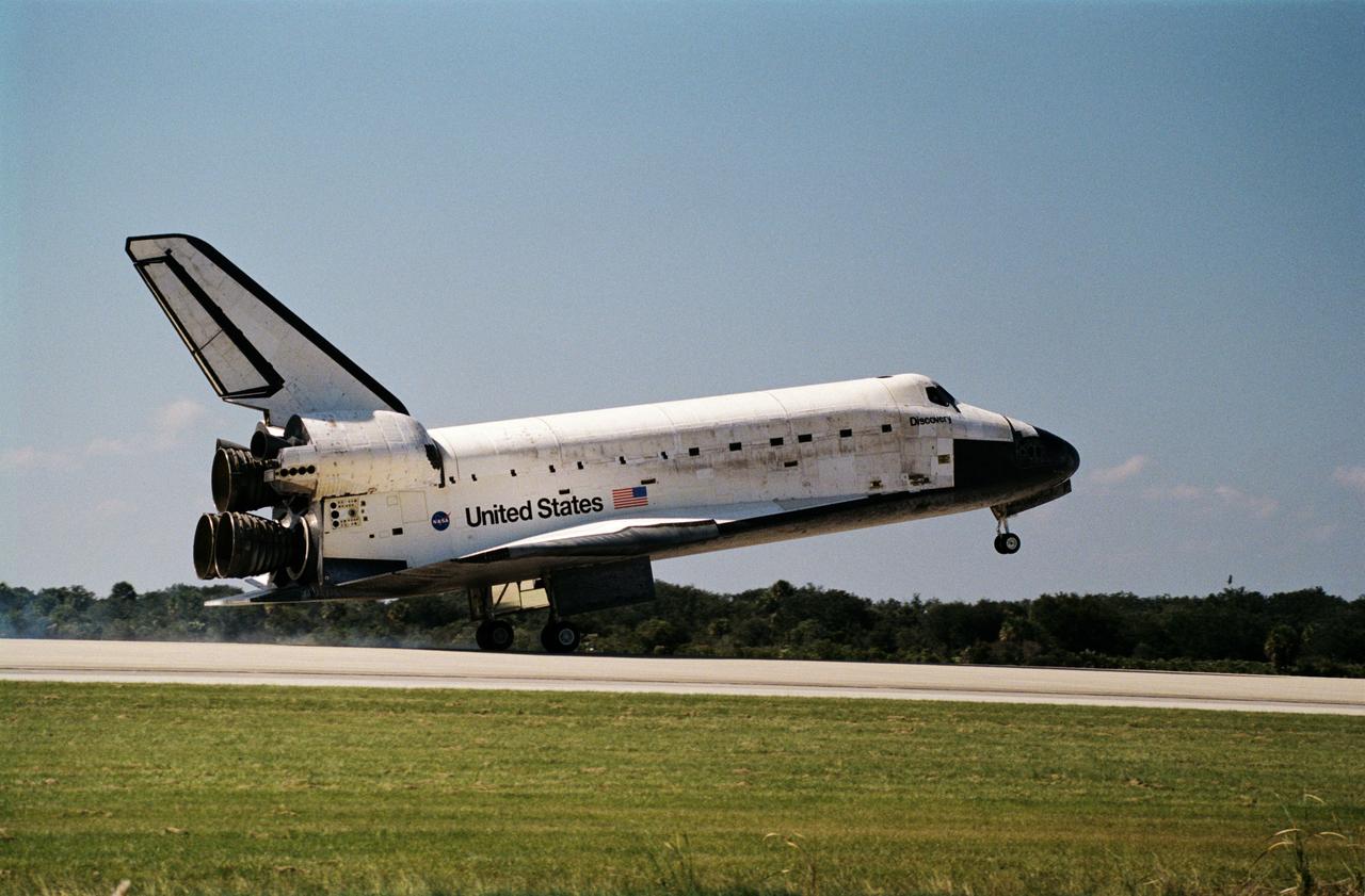 STS095-S-012 (7 Nov. 1998) --- The space shuttle Discovery is about to lower its nose wheel following main gear touchdown on Runway 33 at the Shuttle Landing Facility at the Kennedy Space Center (KSC). Main gear touchdown was at 12:04 p.m. (EST), landing on orbit 135. Discovery returned to Earth with its crew of five astronauts and two payload specialists to successfully complete the nine-day mission. Onboard were astronauts Curtis L. Brown Jr., Steven W. Lindsey, Scott F. Parazynski, Stephen K. Robinson, Pedro Duque and payload specialists Chiaki Naito-Mukai and United States Senator John H. Glenn Jr. Duque represents the European Space Agency (ESA) and Mukai is with Japan's National Space Development Agency (NASDA). Photo credit: NASA