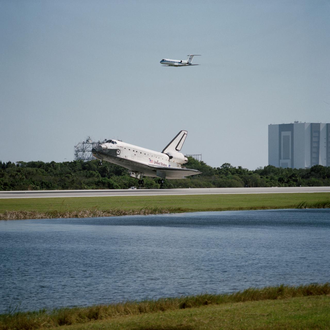 STS095-S-015 (7 Nov. 1998) --- The main landing gear of the space shuttle Discovery is about to touch down on Runway 33 at the Shuttle Landing Facility at the Kennedy Space Center (KSC). Main gear touchdown was at 12:04 p.m. (EST), landing on orbit 135. Discovery returned to Earth with its crew of five astronauts and two payload specialists to successfully complete the nine-day mission. A Shuttle Training Aircraft (STA) is at top center, with the Vehicle Assembly Building (VAB) at right edge of frame.  Onboard were astronauts Curtis L. Brown Jr., Steven W. Lindsey, Scott F. Parazynski, Stephen K. Robinson, Pedro Duque and payload specialists Chiaki Naito-Mukai and United States Senator John H. Glenn Jr.  Duque represents the European Space Agency (ESA) and Mukai is with Japan's National Space Development Agency (NASDA). Photo credit: NASA