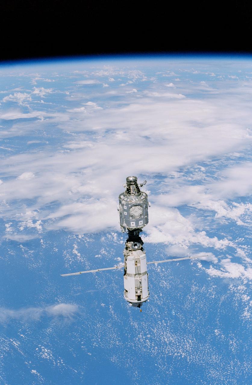 STS096-333-021 (3 June 1999) --- Backdropped against white clouds and blue ocean waters, the  International Space Station (ISS) moves away from the Space Shuttle Discovery. The U.S.-built Unity node  (left) and the Russian-built Zarya or FGB module (with the solar array panels deployed) were joined during a December 1998 mission.  A portion of the work performed on the May 30 space walk by astronauts Tamara E. Jernigan and Daniel T. Barry is evident at various points on the ISS, including the installation of the Russian-built  crane (called Strela).  A STS-96 crew member aboard Discovery recorded this image with a 35mm camera on June 3, 1999.