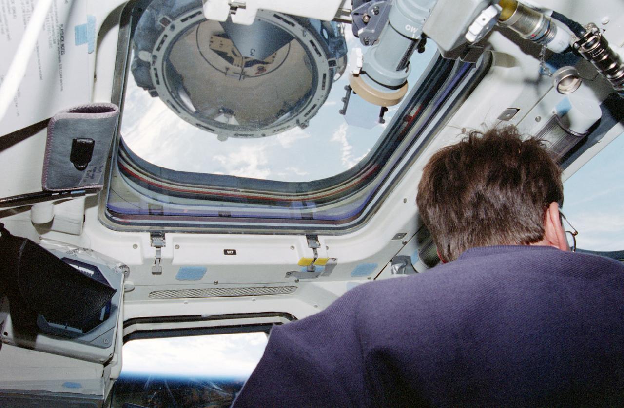 STS096-361-025 (29 May 1999) --- Astronaut Kent V. Rominger, mission commander, is about to accomplish the successful docking of Discovery to the International Space Station (ISS). Rominger is at the shuttle's controls on the aft flight deck. The docking mechanism of the approaching station is just a few meters away on the other side of the overhead window. Rominger was joined by four other American astronauts, a Canadian astronaut and a Russian cosmonaut for almost ten days in space, most of which were devoted to preparing the ISS.