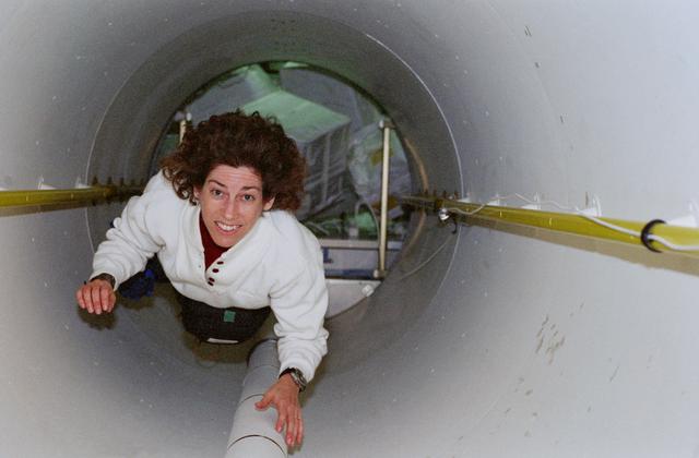 NASA image: Ellen Ochoa floats through transfer tunnel from Spacehab