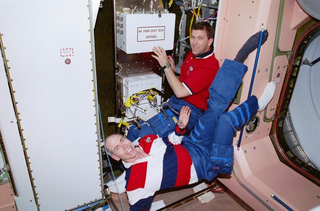 NASA image: Daniel Barry, Rick Husband work with Early Comm hardware in Node 1/Unity module