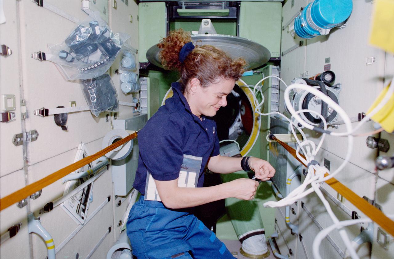 STS096-409-010 (27 May - 6 June 1999) --- Astronaut Julie Payette works inside the Russian-built Zarya module as she joins other members of the STS-96 crew (out of frame) in applying final touches on the elements of the International Space Station (ISS), which was docked with Discovery.   Payette, an alumnus of the 1996 class of astronaut trainees, represents the Canadian Space Agency (CSA).