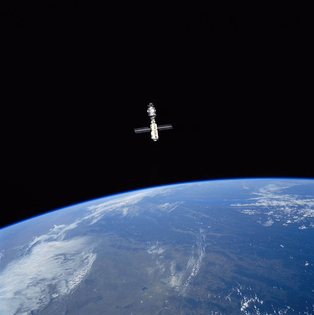 STS096-715-028 (3 June 1999)  --- A STS-96 crew member aboard Discovery recorded this distant image of the International Space Station (ISS) with a 70mm camera following separation of the two spacecraft.    Russia's Lake Baykal, not far from the Mongolian border,  can be seen in the background of the horizon view of Earth.