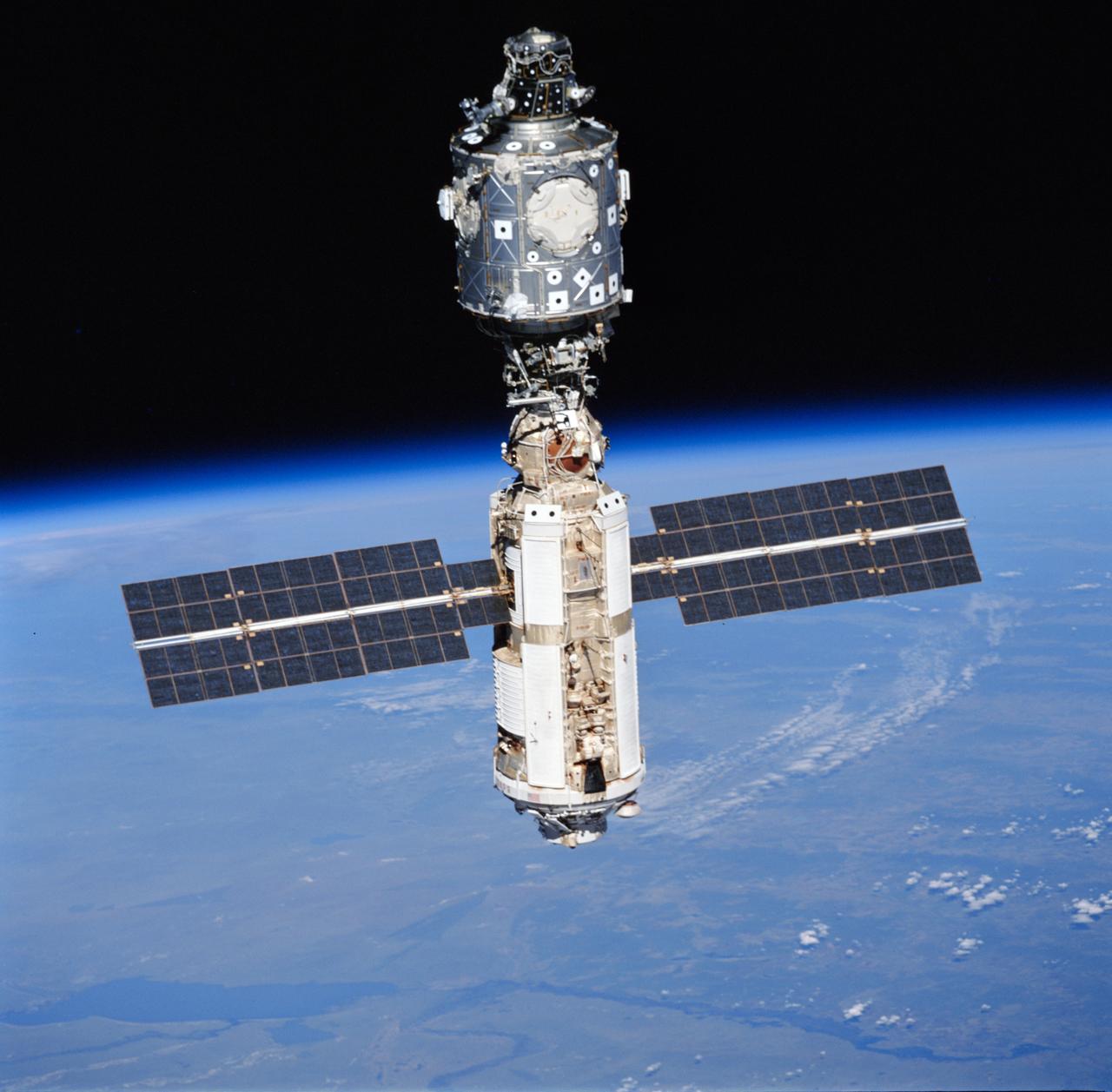 STS096-715-042 (3 June 1999)  --- A STS-96 crew member aboard Discovery recorded this image of the International Space Station (ISS) with a 70mm camera during a fly-around following separation of the two spacecraft.  Lake Hulun Nur in the People's Republic of China is visible in the lower left portion of the frame.  A portion of the work performed on the May 30 space walk by astronauts Tamara E. Jernigan and Daniel T. Barry is evident at various points on the ISS, including the installation of the Russian-built  crane (called Strela) and the U.S.-built crane.