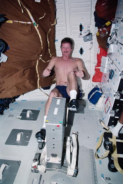 NASA image: MS Tanner exercises on a cycle ergometer during STS-97