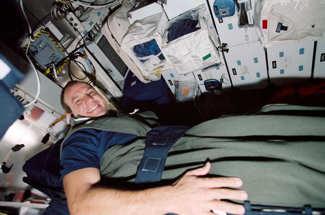 STS097-327-027 (30 Nov.-11 Dec. 2000) --- Astronaut Michael J. Bloomfield, STS-97 pilot, prepares for his sleep shift on the middeck of the Earth-orbiting Space Shuttle Endeavour.