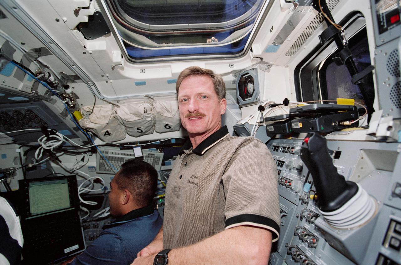 STS097-330-029 (30 Nov.-11 Dec. 2000) --- Astronauts Carlos I. Noriega (left) and Joseph R. Tanner, both mission specialists, are photographed on the aft flight deck of the Space Shuttle Endeavour.