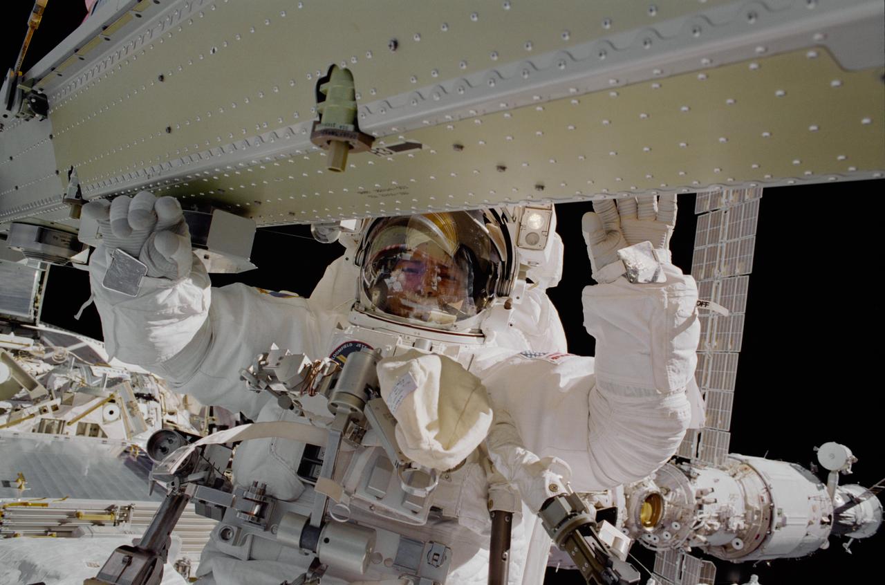 STS097-376-018 (7 December 2000) --- Astronaut Carlos I. Noriega, mission specialist, is photographed during the final of the three space walks scheduled for the STS-97 mission to the International Space Station (ISS). Astronaut Joseph R. Tanner, mission specialist, was nearby when he exposed the 35mm frame.