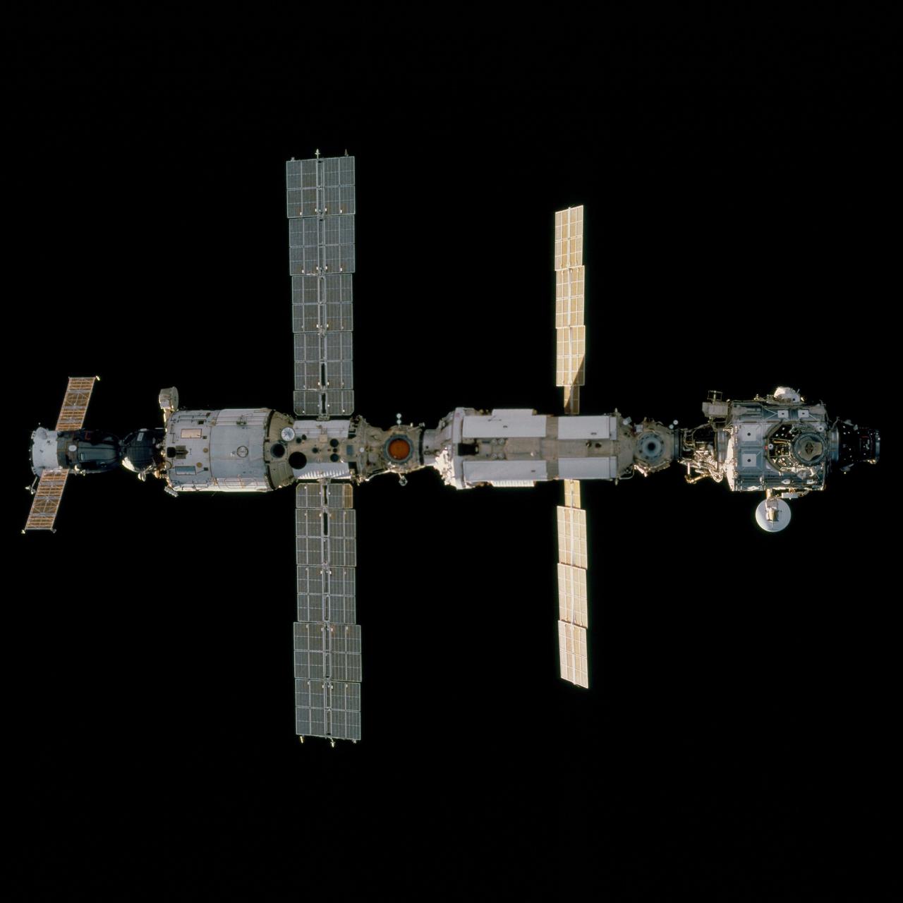 STS097-702-061 (2 December 2000) --- The International Space Station (ISS) moves in position for docking with the Space Shuttle Endeavour, in this 70mm frame photographed by one of the STS-97 astronauts on the flight deck of the shuttle. Most of the station's components are clearly visible in the frame, with the Soyuz spacecraft docked at left to the Zvezda Service Module, which is linked to the Zarya or Functional Cargo Block (FGB). The Unity node is at right, sporting the additions from the recent STS-92 mission of the Z1 truss structure (largely obscured) and a Pressurized Mating Adapter (PMA-3).