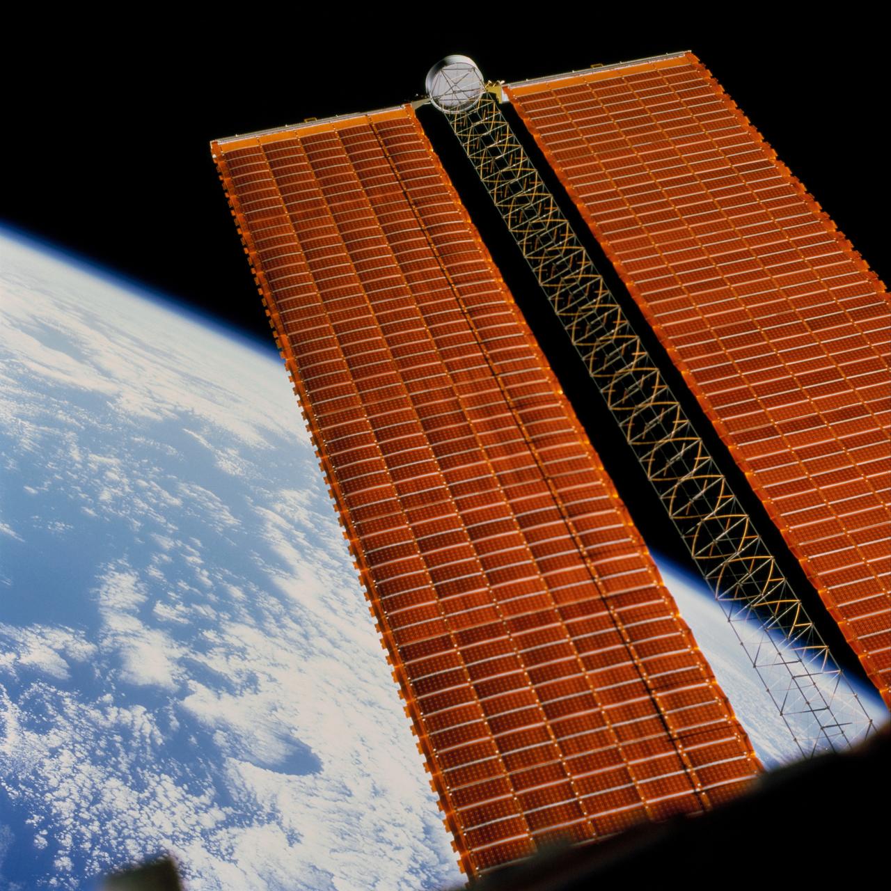 STS097-702-070 (3 December 2000) --- An astronaut inside Endeavour's crew cabin used a handheld 70mm camera to expose this frame of the International Space Station's starboard solar array wing panel, backdropped against an Earth horizon scene.