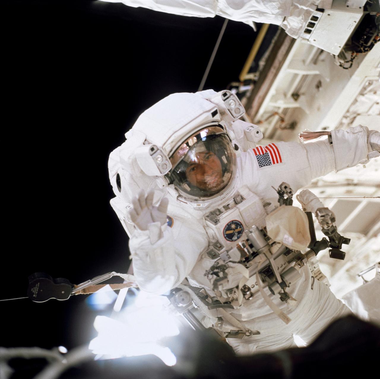STS097-703-021 (30 Nov.-11 Dec. 2000) --- Astronaut Carlos I. Noriega, mission specialist, is photographed during one of the three space walks scheduled for the STS-97 mission to the International Space Station (ISS). The photo was taken through an aft flight deck window on the Space Shuttle Endeavour by a crew mate using a 70mm camera.