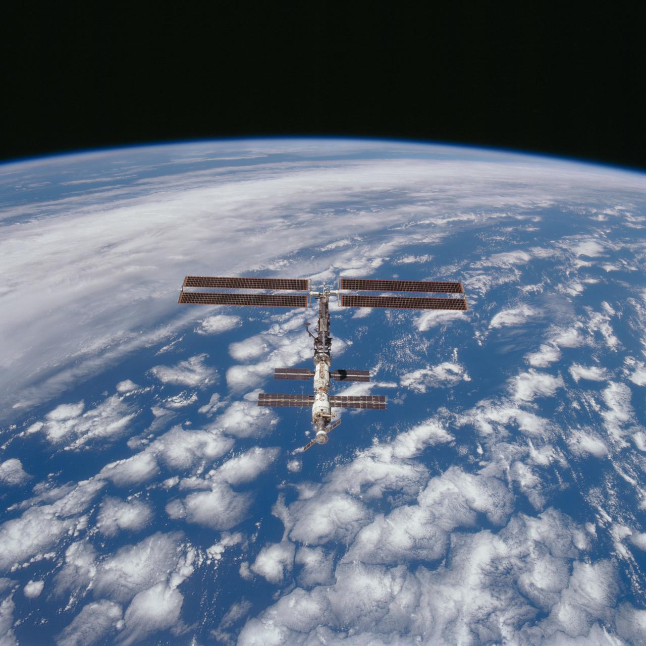 STS097-703-085 (9 December 2000) --- This picture is one of a series of 70mm frames exposed of the International Space Station (ISS) following undocking at 1:13 p.m. (CST), December 9, 2000. This series of images, as well as video and digital still imagery taken at the same time, represent the first imagery of the entire station with its new solar array panels deployed. Before separation, the shuttle and space station had been docked to one another for 6 days, 23 hours and 13 minutes. Endeavour moved downward from the space station, then began a tail-first circle at a distance of about 500 feet. The maneuver, with pilot Michael J. Bloomfield at the controls, took about an hour. While Endeavour flew that circle, the two spacecraft, moving at five miles a second, navigated about two-thirds of the way around the Earth. Undocking took place 235 statute miles above the border of Kazakhstan and China. When Endeavour made its final separation burn, the orbiter and the space station were near the northeastern coast of South America.