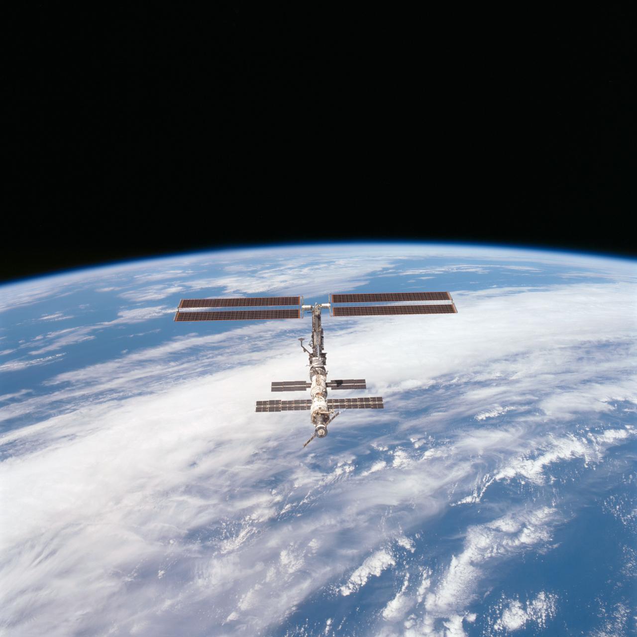 STS097-703-093 (9 December 2000) --- This picture is one of a series of 70mm frames exposed of the International Space Station (ISS) following undocking at 1:13 p.m. (CST), December 9, 2000. This series of images, as well as video and digital still imagery taken at the same time, represent the first imagery of the entire station with its new solar array panels deployed. Before separation, the shuttle and space station had been docked to one another for 6 days, 23 hours and 13 minutes. Endeavour moved downward from the space station, then began a tail-first circle at a distance of about 500 feet. The maneuver, with pilot Michael J. Bloomfield at the controls, took about an hour. While Endeavour flew that circle, the two spacecraft, moving at five miles a second, navigated about two-thirds of the way around the Earth. Undocking took place 235 statute miles above the border of Kazakhstan and China. When Endeavour made its final separation burn, the orbiter and the space station were near the northeastern coast of South America.