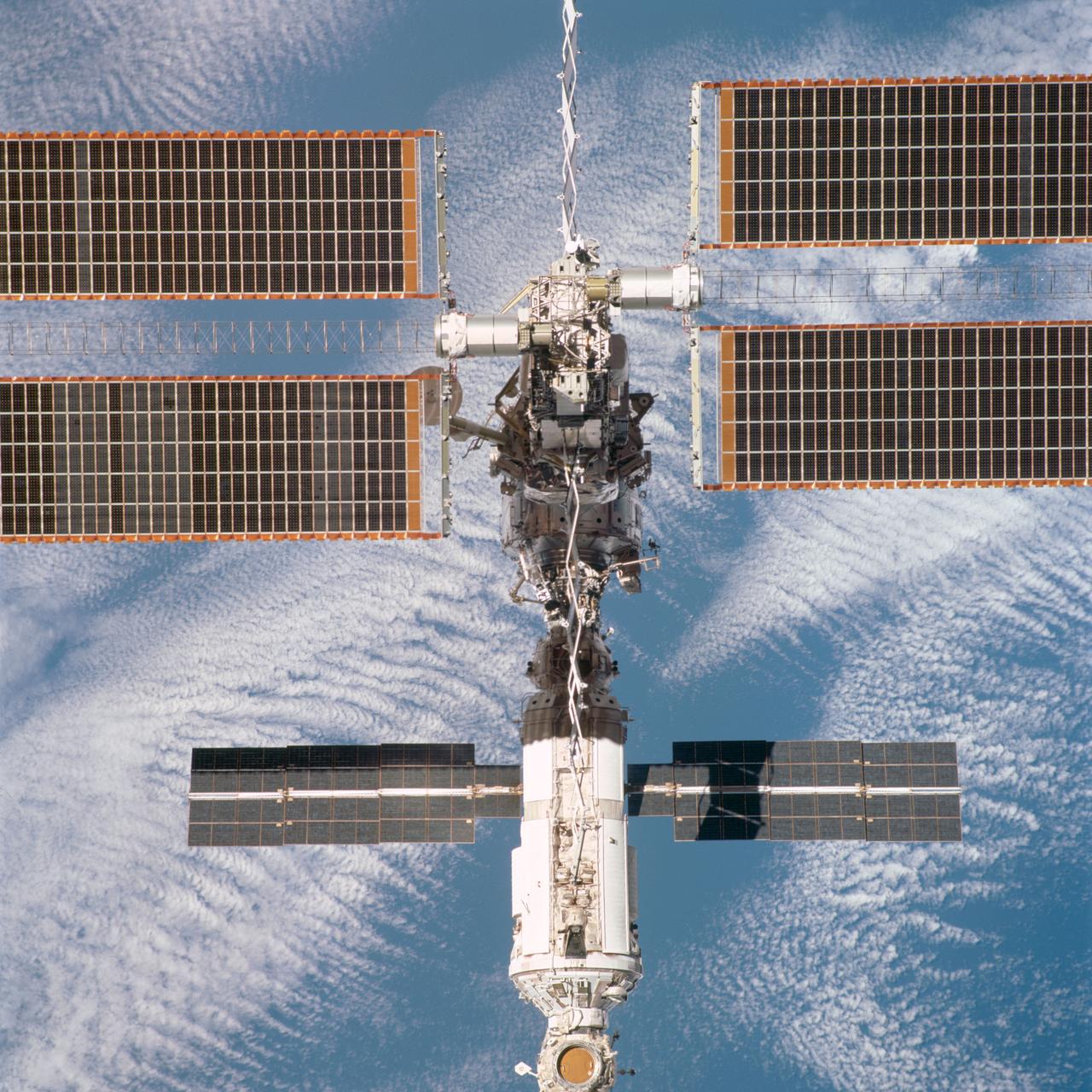 STS097-704-063 (9 December 2000) --- This overhead view is one of a series of 70mm frames exposed of the International Space Station (ISS) following undocking at 1:13 p.m. (CST), December 9, 2000. This series of images, as well as video and digital still imagery taken at the same time, represent the first imagery of the entire station with its new solar array panels deployed. Before separation, the shuttle and space station had been docked to one another for 6 days, 23 hours and 13 minutes. Endeavour moved downward from the space station, then began a tail-first circle at a distance of about 500 feet. The maneuver, with pilot Michael J. Bloomfield at the controls, took about an hour. While Endeavour flew that circle, the two spacecraft, moving at five miles a second, navigated about two-thirds of the way around the Earth. Undocking took place 235 statute miles above the border of Kazakhstan and China. When Endeavour made its final separation burn, the orbiter and the space station were near the northeastern coast of South America.