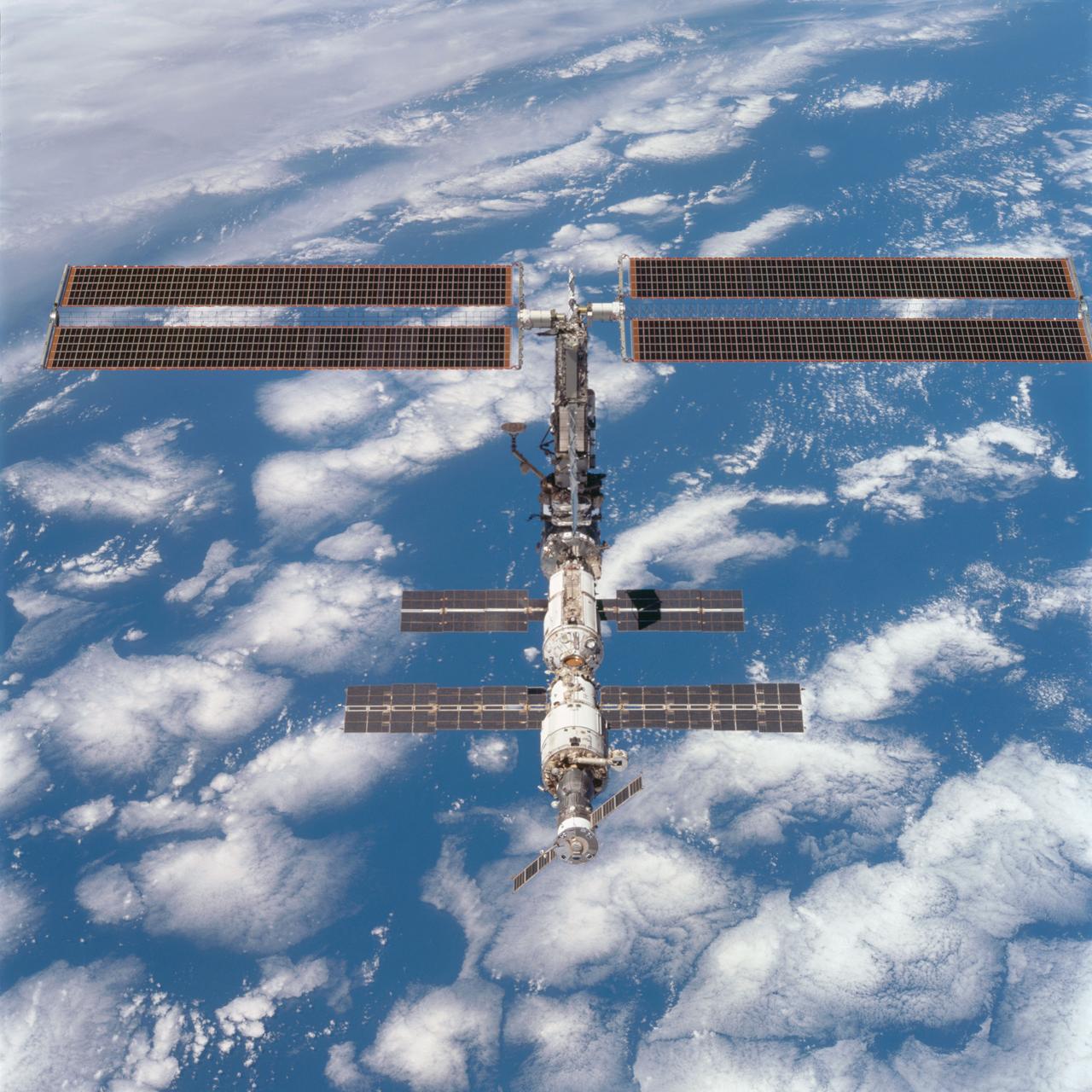 STS097-704-071 (9 December 2000) --- This picture is one of a series of 70mm frames exposed of the International Space Station (ISS) following undocking at 1:13 p.m. (CST), December 9, 2000. This series of images, as well as video and digital still imagery taken at the same time, represent the first imagery of the entire station with its new solar array panels deployed. Before separation, the shuttle and space station had been docked to one another for 6 days, 23 hours and 13 minutes. Endeavour moved downward from the space station, then began a tail-first circle at a distance of about 500 feet. The maneuver, with pilot Michael J. Bloomfield at the controls, took about an hour. While Endeavour flew that circle, the two spacecraft, moving at five miles a second, navigated about two-thirds of the way around the Earth. Undocking took place 235 statute miles above the border of Kazakhstan and China. When Endeavour made its final separation burn, the orbiter and the space station were near the northeastern coast of South America.