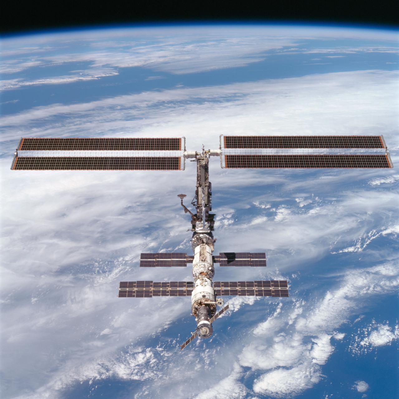 STS097-704-074 (9 December 2000) --- This picture is one of a series of 70mm frames exposed of the International Space Station (ISS) following undocking at 1:13 p.m. (CST), December 9, 2000. This series of images, as well as video and digital still imagery taken at the same time, represent the first imagery of the entire station with its new solar array panels deployed. Before separation, the shuttle and space station had been docked to one another for 6 days, 23 hours and 13 minutes. Endeavour moved downward from the space station, then began a tail-first circle at a distance of about 500 feet. The maneuver, with pilot Michael J. Bloomfield at the controls, took about an hour. While Endeavour flew that circle, the two spacecraft, moving at five miles a second, navigated about two-thirds of the way around the Earth. Undocking took place 235 statute miles above the border of Kazakhstan and China. When Endeavour made its final separation burn, the orbiter and the space station were near the northeastern coast of South America.