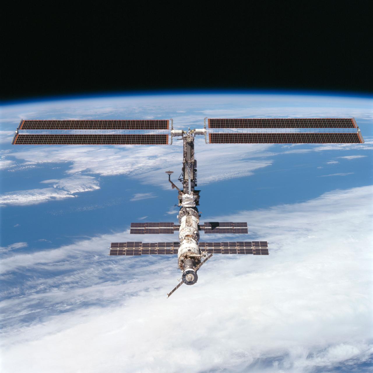 STS097-704-080 (9 December 2000) --- This picture is one of a series of 70mm frames exposed of the International Space Station (ISS) following undocking at 1:13 p.m. (CST), December 9, 2000. This series of images, as well as video and digital still imagery taken at the same time, represent the first imagery of the entire station with its new solar array panels deployed. Before separation, the shuttle and space station had been docked to one another for 6 days, 23 hours and 13 minutes. Endeavour moved downward from the space station, then began a tail-first circle at a distance of about 500 feet. The maneuver, with pilot Michael J. Bloomfield at the controls, took about an hour. While Endeavour flew that circle, the two spacecraft, moving at five miles a second, navigated about two-thirds of the way around the Earth. Undocking took place 235 statute miles above the border of Kazakhstan and China. When Endeavour made its final separation burn, the orbiter and the space station were near the northeastern coast of South America.