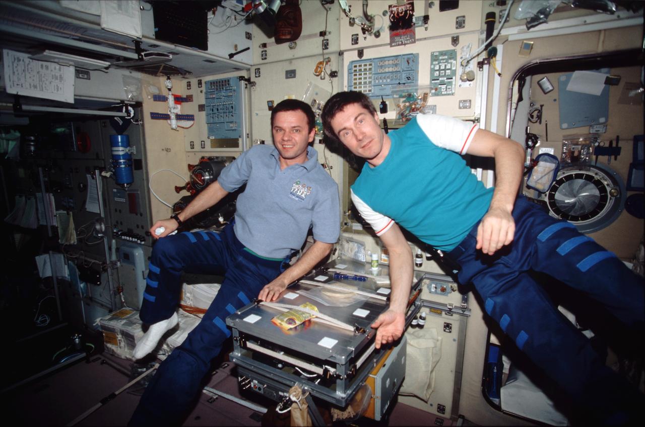 STS098-314-0017 (7-20 February 2001) ---  Cosmonauts Yuri P. Gidzenko (left), Expedition One Soyuz commander; and Sergei K. Krikalev, flight engineer, are pictured in the Zvezda service module  while hosting the STS-98 crew on the International Space Station (ISS). The two, who represent the Russian Aviation and Space Agency, along with astronaut  William M. (Bill) Shepherd (out of frame), mission commander, have been on the outpost since early November 2000.