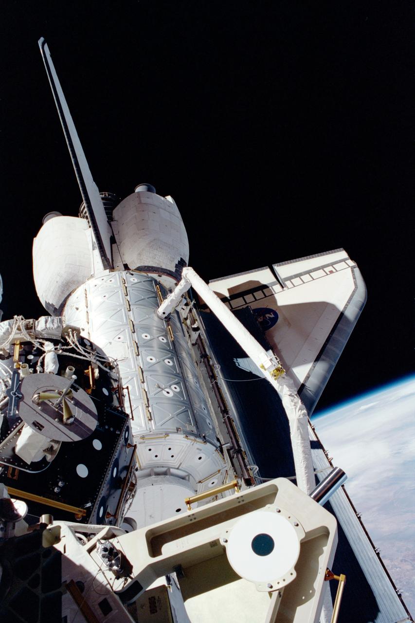 STS098-331-005 (7-20 February 2001) --- In the grasp of the shuttle’s remote manipulator system (RMS) robot arm, the Destiny laboratory is moved from its stowage position in the cargo bay of the Space Shuttle Atlantis. The photo was taken by astronaut Thomas D. Jones, who was participating in one of three STS-98/5a spacewalks at the time. Astronaut Robert L. Curbeam (out of frame) also made the three spacewalks.