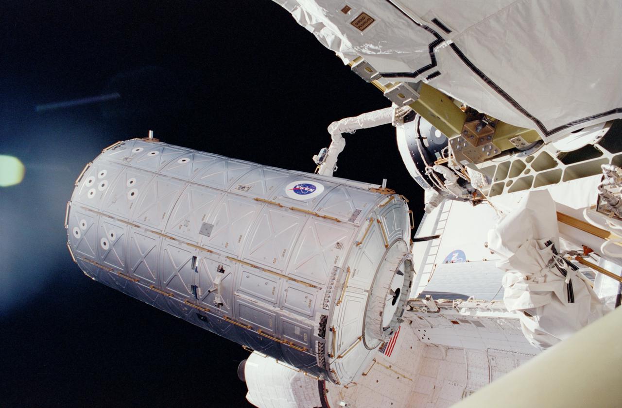 STS098-331-0017 (7-20 February 2001) --- In the grasp of the shuttle's remote manipulator system (RMS) robot arm, the Destiny laboratory is moved from its stowage position in the cargo bay of the Space Shuttle Atlantis. The photo was taken by astronaut Thomas D. Jones, who was participating in one of three STS-98/5a space walks at the time. Astronaut Robert L. Curbeam (out of frame) also made the three space walks.