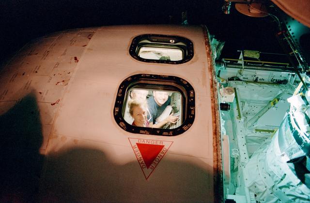 NASA image: CDR Cockrell, PLT Polansky, and MS Ivins peer through AFD overhead windows