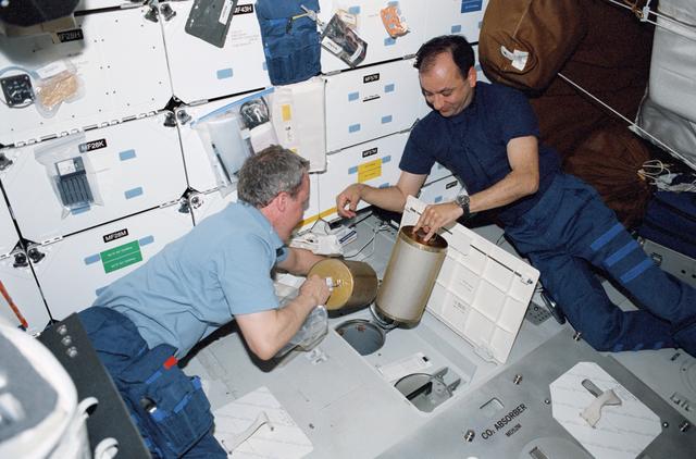 NASA image: Jones and Polansky perform a LiOH Canister changeout on Atlantis' MDK