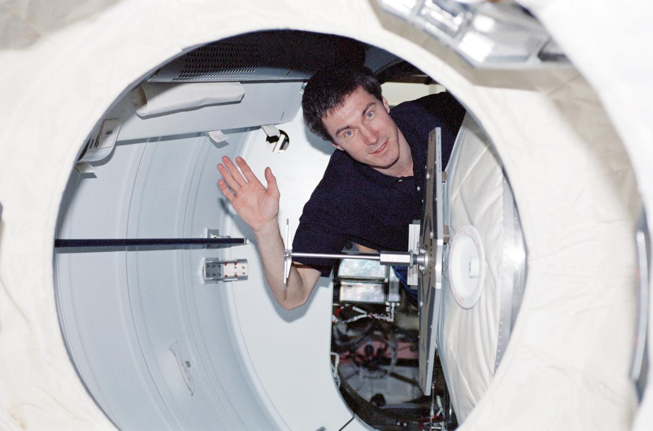 STS098-355-017 (7-20 February 2001) --- Cosmonaut Sergei K. Krikalev, Expedition One flight engineer, waves as he moves the hatch of the Pressurized Mating Adapter (PMA) leading to the Space Shuttle Atlantis. Krikalev represents Rosaviakosmos.