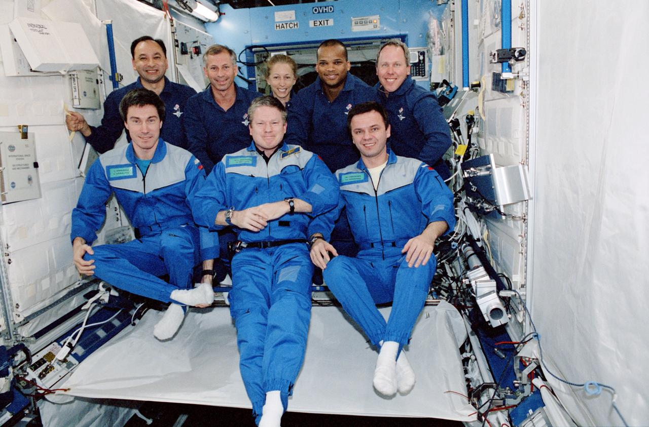 STS098-371-0019 (7-20 February 2001) --- The crews of the Space Shuttle Atlantis and International Space Station (ISS) interrupt work aboard the newly installed Destiny laboratory to pose for an in-flight joint group portrait. In front are (from the left) cosmonaut Sergei K. Krikalev, Expedition One flight engineer; astronaut William M. (Bill) Shepherd, Expedition One mission commander; and Yuri P. Gidzenko, Soyuz commander. The shuttle crew is made up of (from the left) astronauts Mark L. Polansky, pilot; Kenneth D. Cockrell, mission commander; and Marsha S. Ivins, Robert L. Curbeam and Thomas D. Jones, all mission specialists. Krikalev and Gidzenko represent the Russian Aviation and Space Agency.