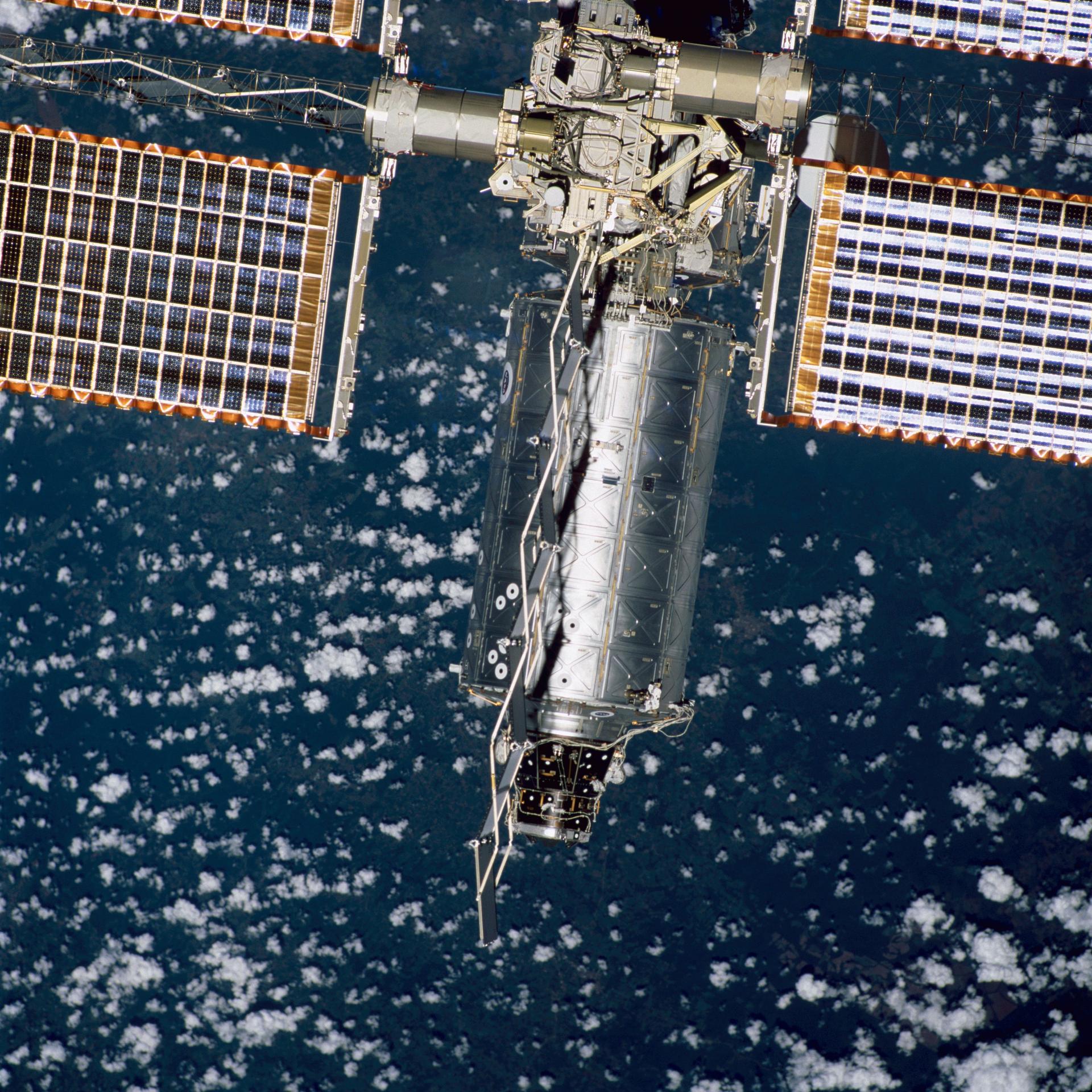 Backdropped by Earth dotted with clouds, this close-up view of the newly-attached Destiny laboratory on the International Space Station was photographed during the STS-98 mission after space shuttle Atlantis undocked on Feb. 16, 2001.