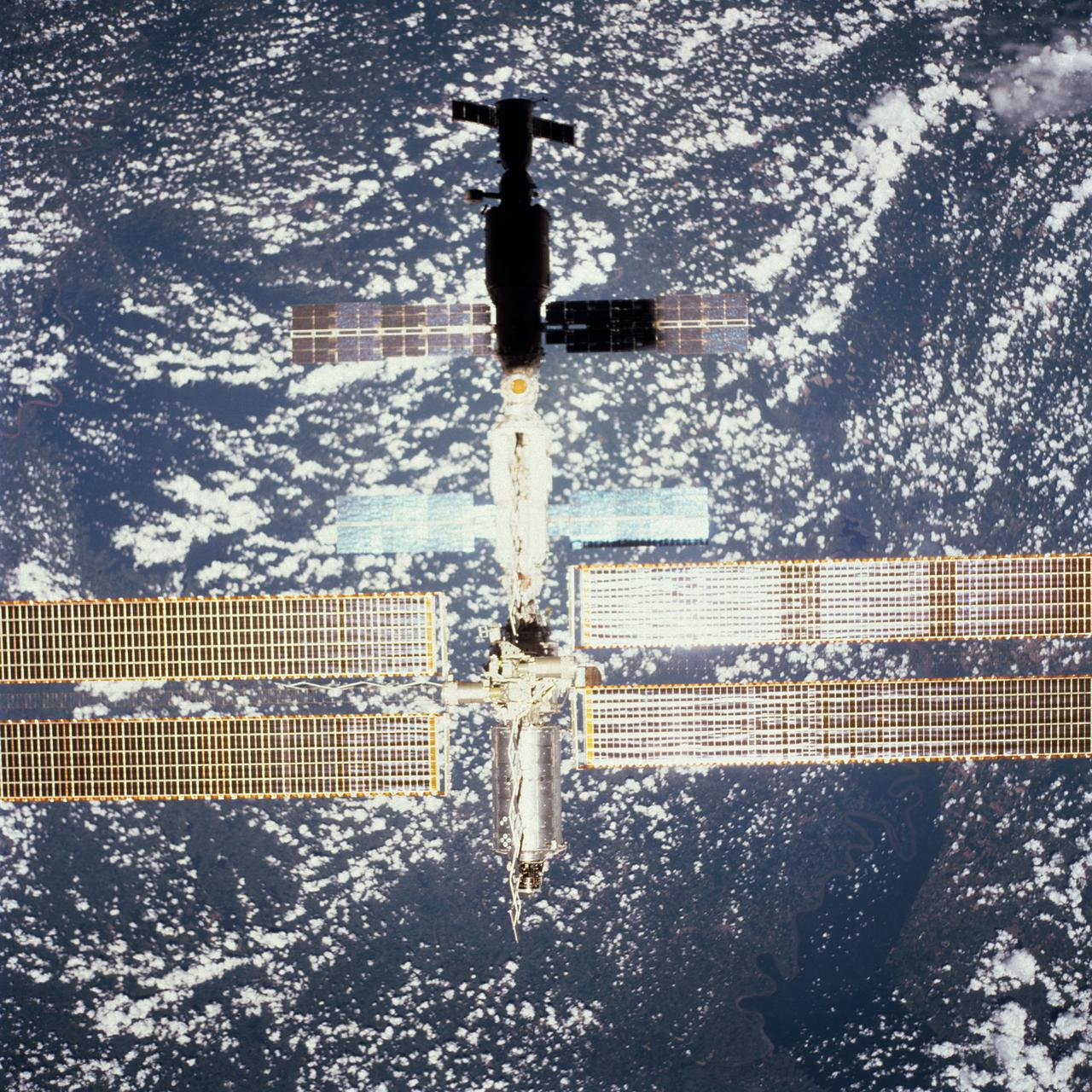STS098-713A-075 (16 February 2001) --- Backdropped by Earth dotted with clouds, this close-up view of the International Space Station (ISS) with the newly-attached Destiny laboratory, was photographed by one of the astronauts onboard Atlantis. As the primary payload for the STS-98 mission, Destiny is the centerpiece of the ISS, where unprecedented science experiments will be performed in space. The shuttle and the station parted company at 8:06 a.m. (CST), Feb. 16, as Polansky flew the shuttle halfway around the outpost and its new Destiny laboratory before moving off.