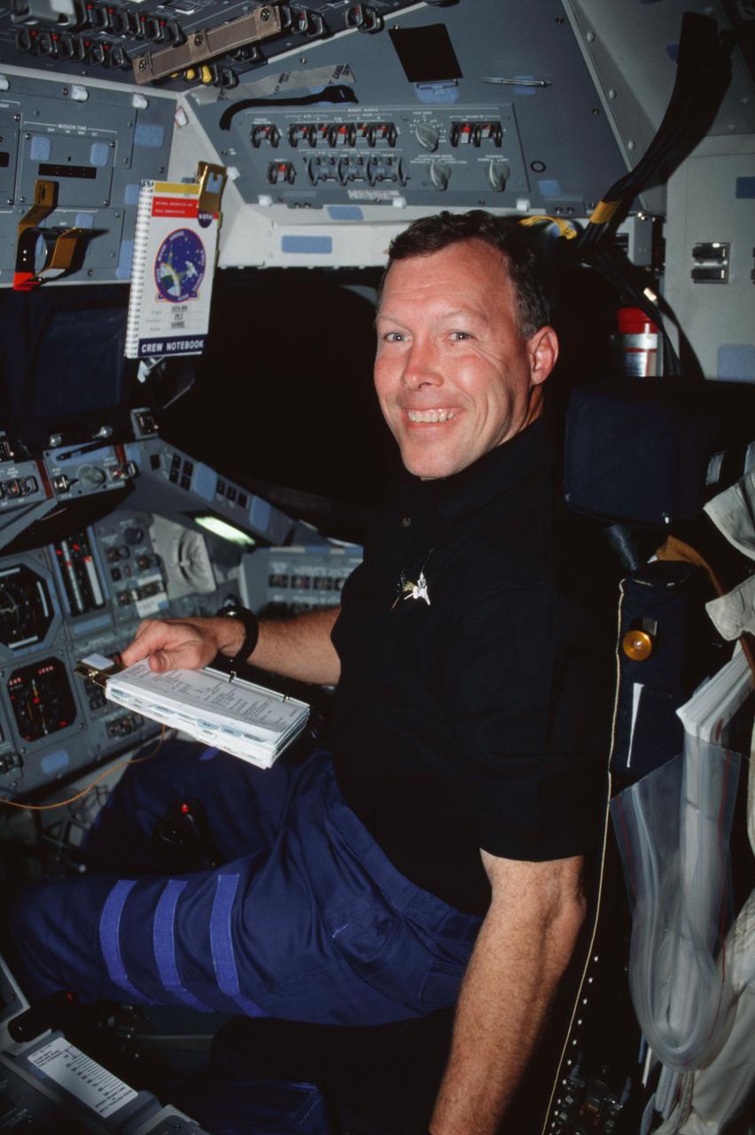 STS099-302-021 (11-22 February 2000) ---  Astronaut Dominic L. Gorie, pilot, keeps  a checklist nearby for consultation on Endeavour's flight deck.