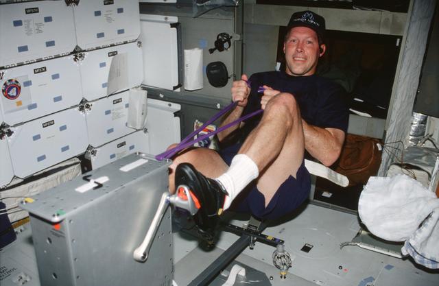 NASA image: STS-99 Pilot Gorie uses an ergometer on OV-105's middeck