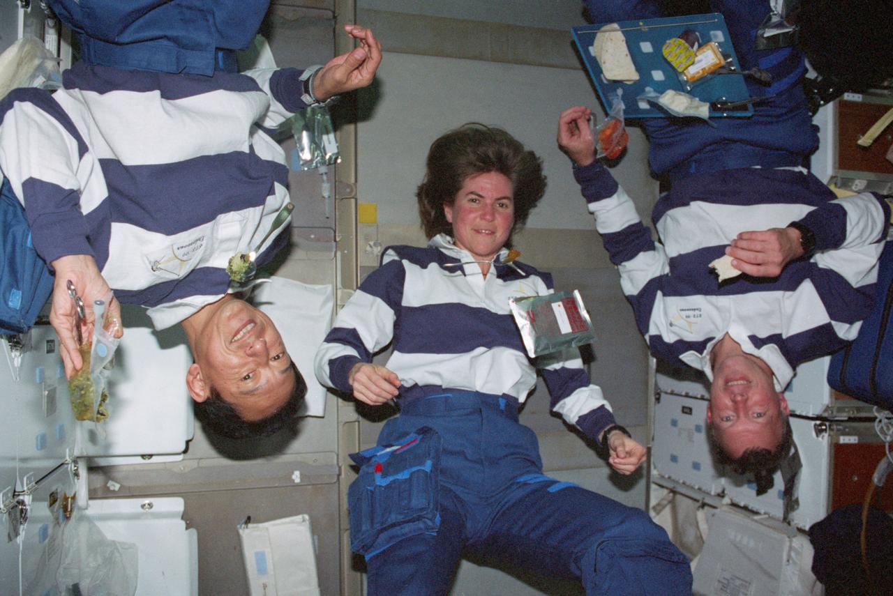 STS099-312-002 (11-22 February 2000) ---Astronauts Mamoru Mohri (left), Janice E. Voss, and Dominic L. Gorie, members of the Blue Team portion of 24-hour Shuttle Radar Topography Mission (SRTM) support, prepare for a meal on the middeck of the Space Shuttle Endeavour. Mohri represents Japan?s National Space Development Agency (NASDA).