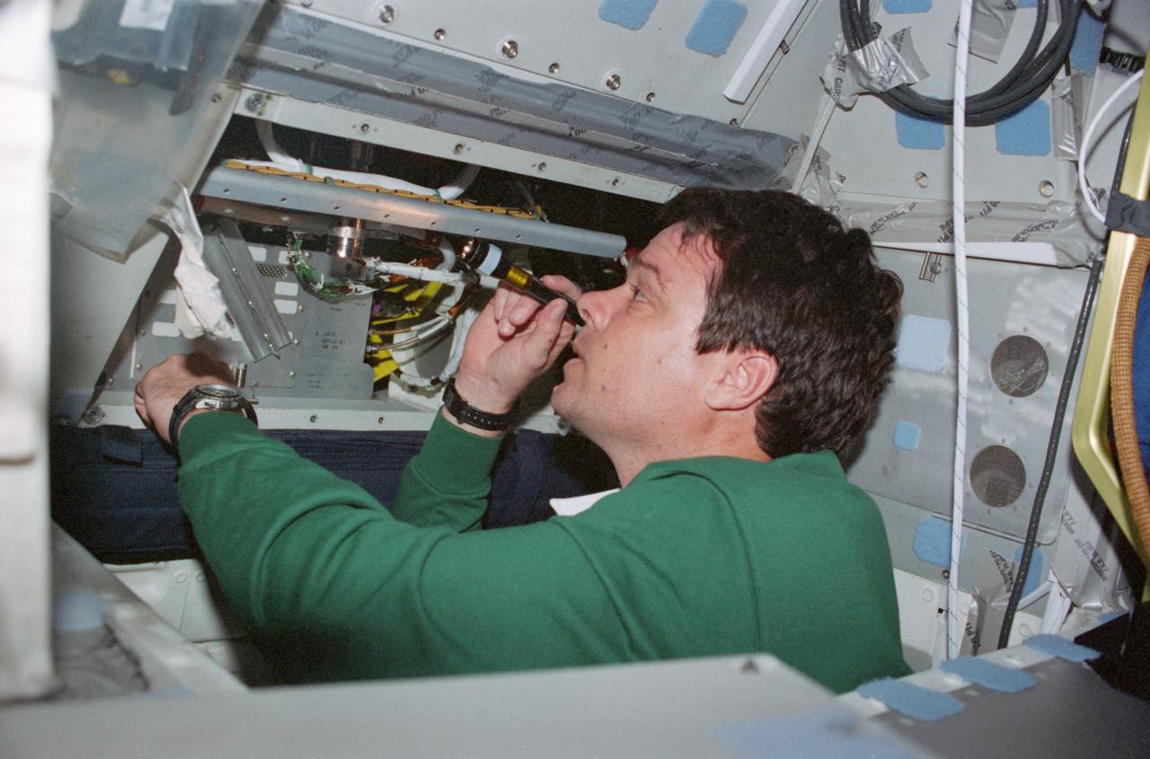 STS099-312-033 (11-22 February 2000) ---Astronaut Kevin R. Kregel, mission commander, works with the Digital Data Routing Equipment (DDRE) on the middeck of the Earth-orbiting Space Shuttle Endeavour.
