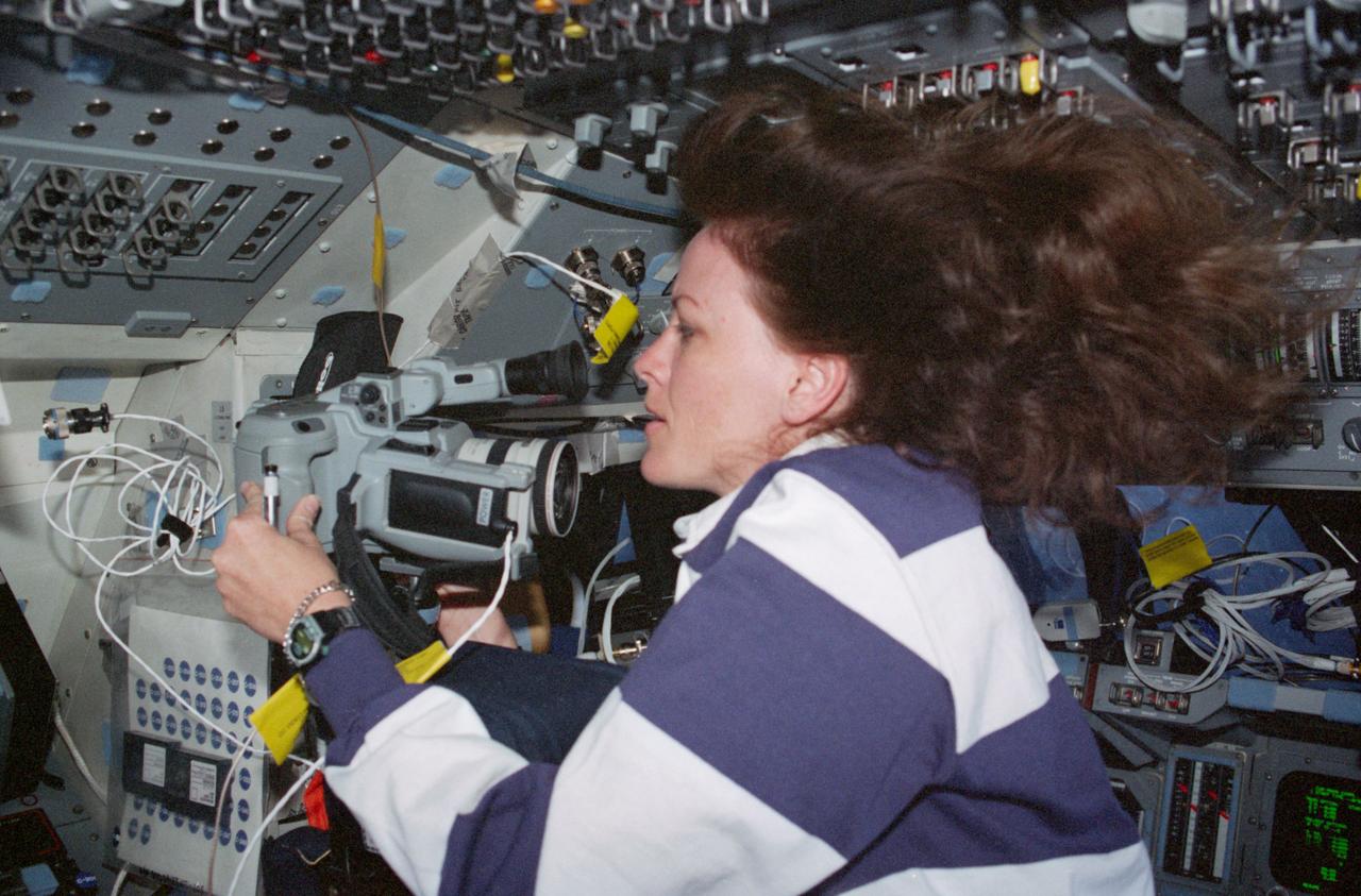 STS099-312-034 (11-22 February 2000) ---Astronaut Janet L. Kavandi, mission specialist, works with camera equipment on the middeck of the Earth-orbiting Space Shuttle Endeavour.