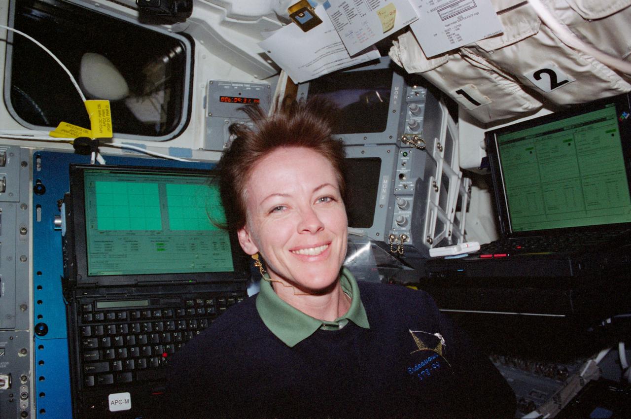 STS099-315-008 (11-22 February 2000) ---Astronaut Janet L. Kavandi, mission specialist, is photographed near the Payload General Support Computers (PGSC) dealing with the Shuttle Radar Topography Mission (SRTM) on the middeck of the Space Shuttle Endeavour.