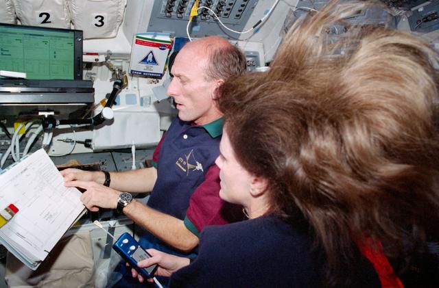 NASA image: STS-99 MS Thiele and MS Kavandi work on OV-105's flight deck